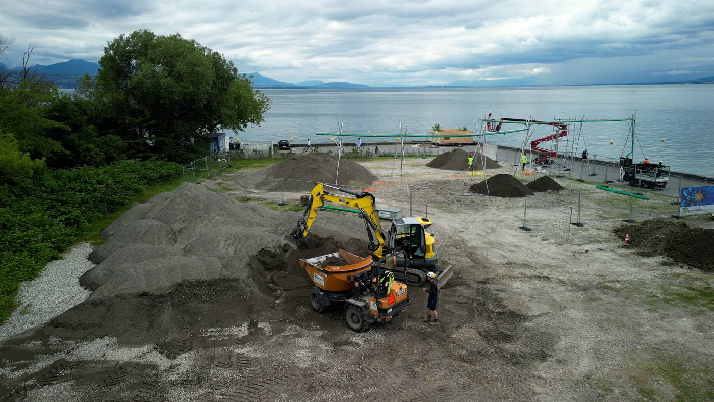 Pelle et dumper sur les tas de sable au bord du lac
